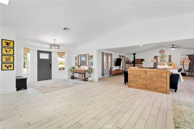 a living room with furniture and kitchen view