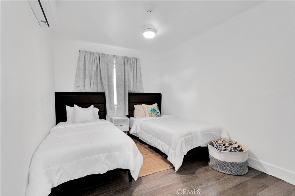 37077 Coyote Lake Road Newberry Springs, CA 92365 - Photo 52 of 58 a bedroom with two beds and a couch