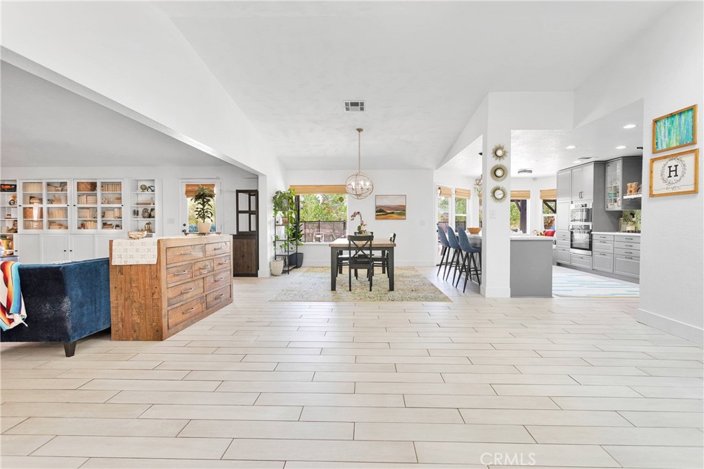 37077 Coyote Lake Road Newberry Springs, CA 92365 - Photo 6 of 58 a living room with couches and kitchen view with wooden floor