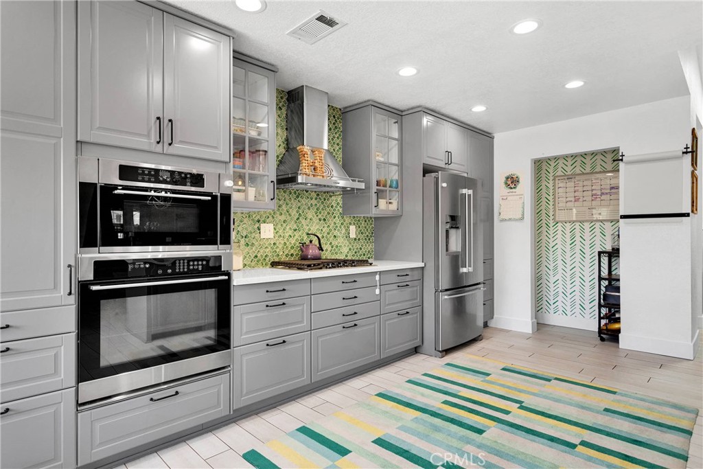 37077 Coyote Lake Road Newberry Springs, CA 92365 - Photo 8 of 58 a kitchen with stainless steel appliances kitchen island granite countertop a refrigerator and a stove top oven