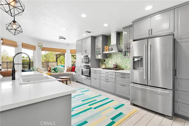 a kitchen with kitchen island white cabinets and stainless steel appliances