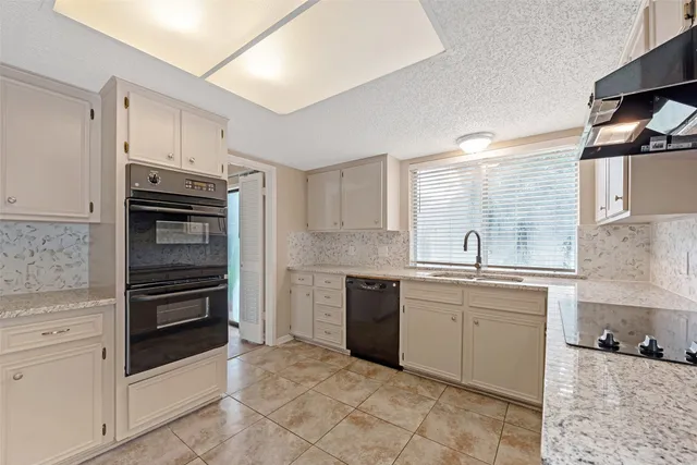 a kitchen with sink cabinets and stainless steel appliances