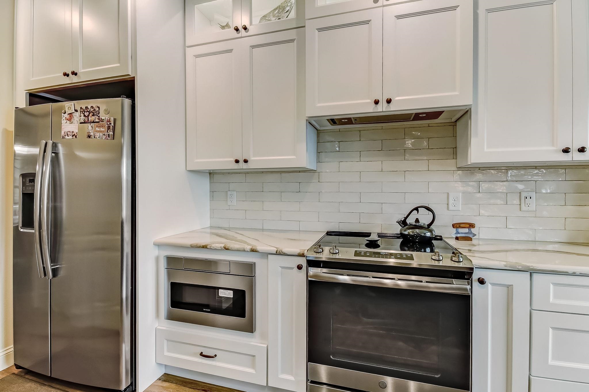 644 Sun Down Circle St. Augustine, FL 32080 - Photo 21 of 69 a kitchen with stainless steel appliances granite countertop white cabinets a stove a sink and dishwasher