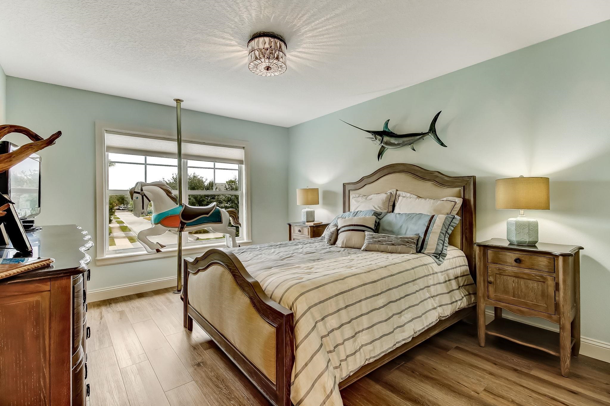 644 Sun Down Circle St. Augustine, FL 32080 - Photo 36 of 69 a bedroom with a bed and a flat tv screen on dresser