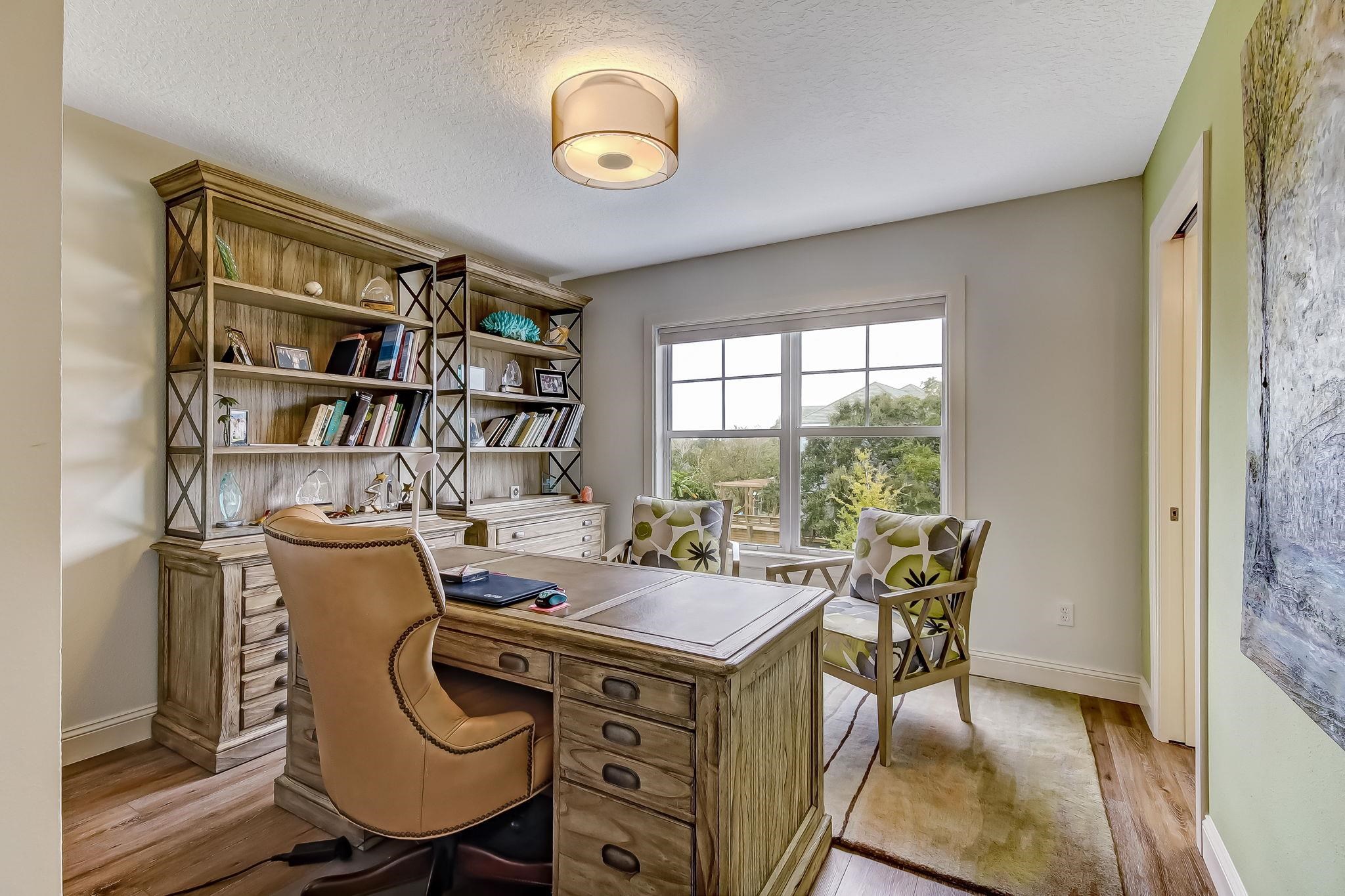 644 Sun Down Circle St. Augustine, FL 32080 - Photo 38 of 69 a view of a workspace with furniture and a bookshelf