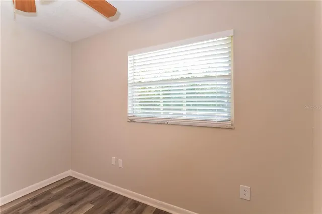 a view of a small space with wooden floor and a window