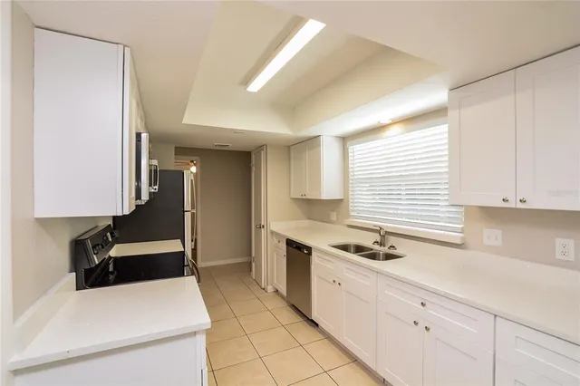 a kitchen with stainless steel appliances kitchen island granite countertop a sink and cabinets