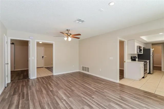 a view of empty room with wooden floor