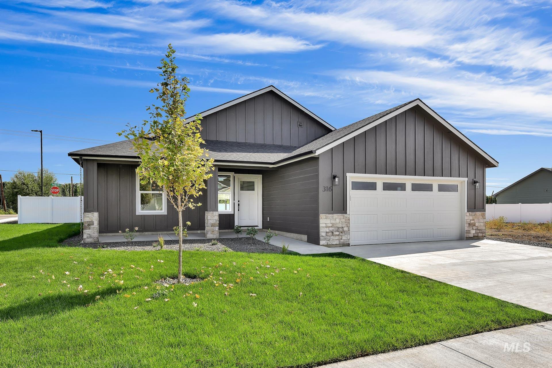 Modern farmhouse style home with a shingled roof, board and batten siding, concrete driveway, stone siding, and a garage