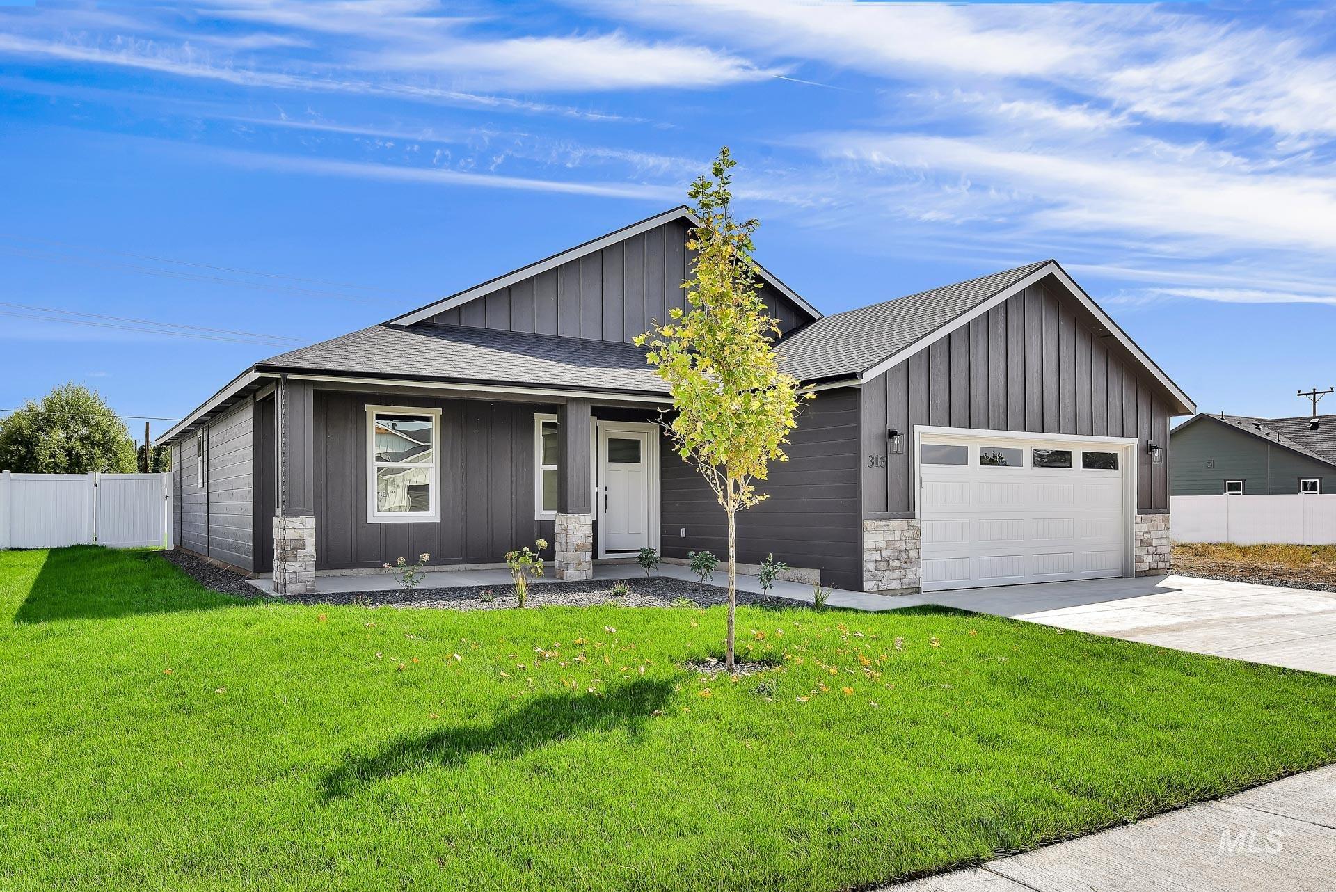 1164 Velvet Loop Wilder, ID 83676 - Photo 2 of 35 View of front of home featuring a shingled roof, board and batten siding, stone siding, and covered porch