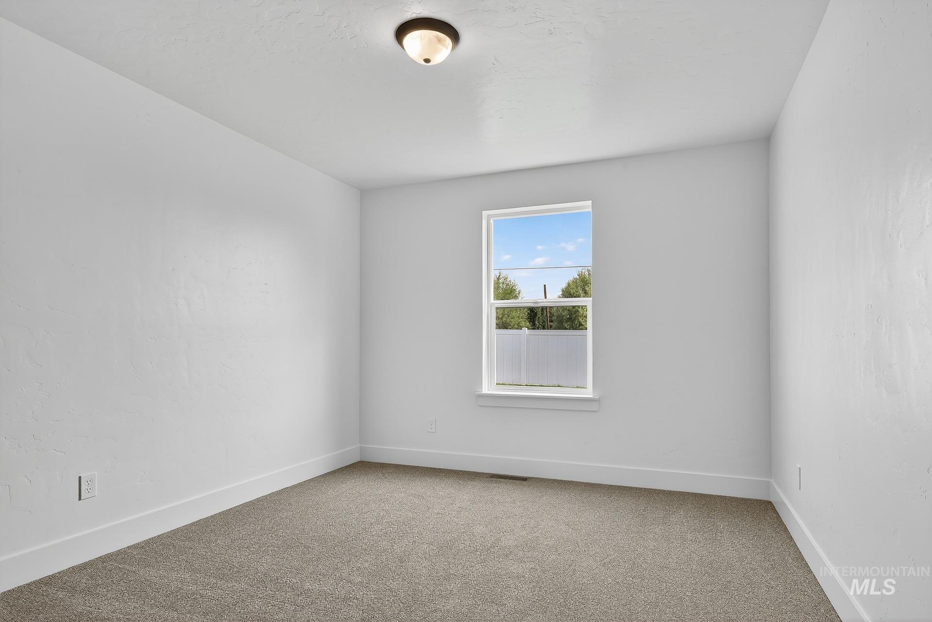 1164 Velvet Loop Wilder, ID 83676 - Photo 22 of 35 Empty room with baseboards and light carpet