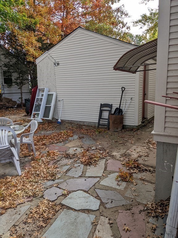 73-75 Sylvan Street Springfield, MA 01108 - Photo 4 of 15 a view of a backyard with chairs and a wooden fence