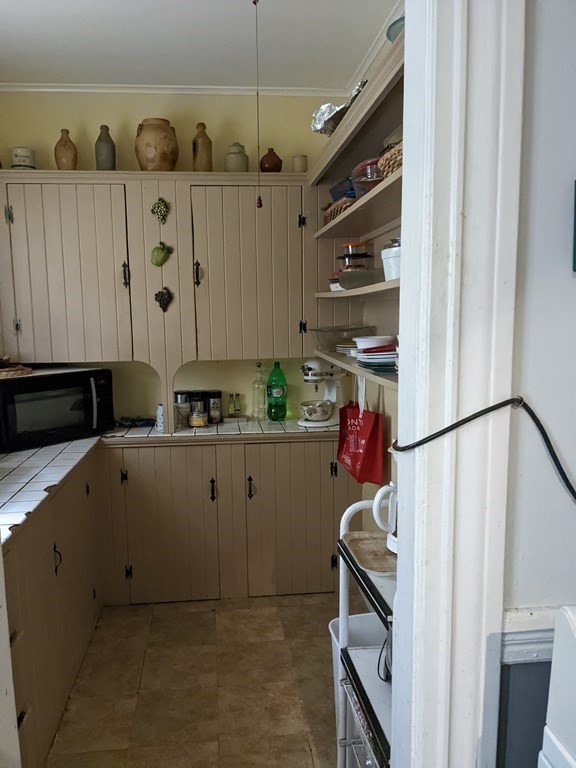 73-75 Sylvan Street Springfield, MA 01108 - Photo 6 of 15 a kitchen with a refrigerator and cabinets