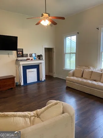 a living room with furniture and a flat screen tv