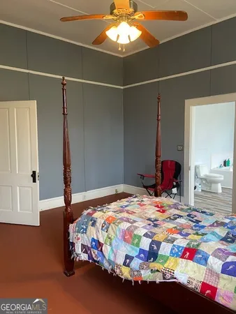 a bedroom with bed and a window
