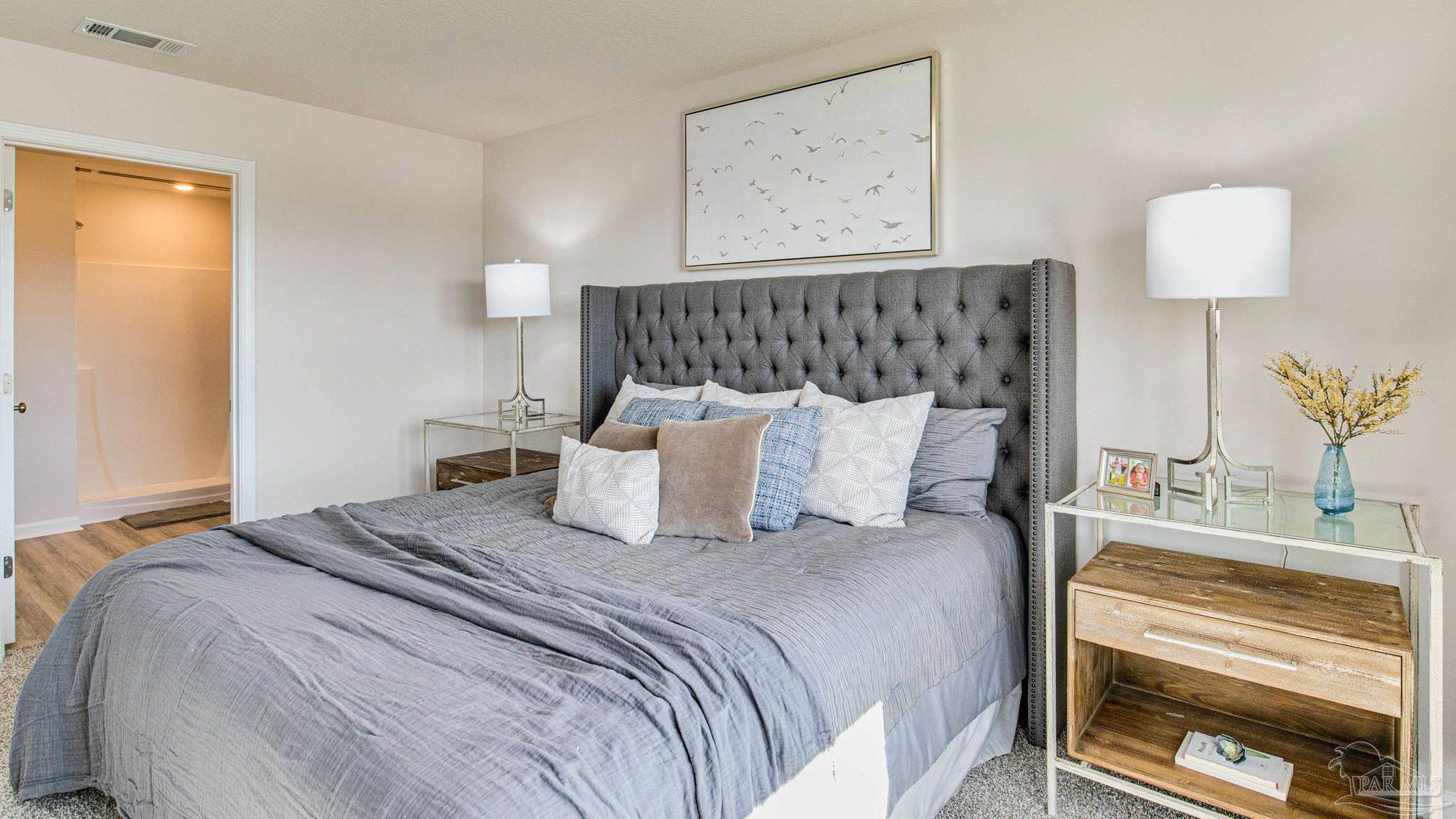 9715 Dutton Lane Milton, FL 32583 - Photo 17 of 33 a bed room with a bed and a night stand