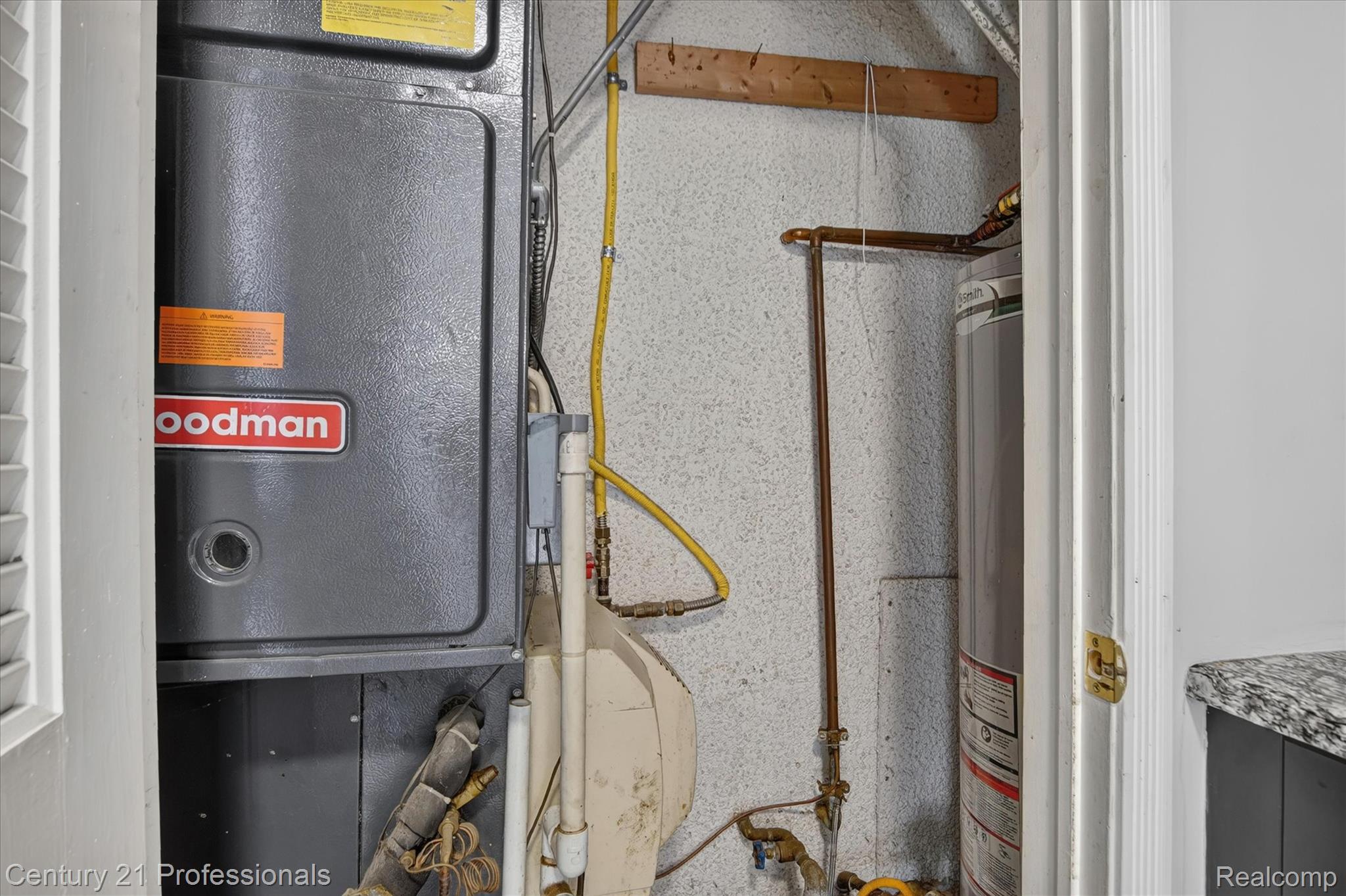 648 Newport Road Carleton, MI 48117 - Photo 23 of 37 Utility closet featuring a Goodman furnace and a water heater