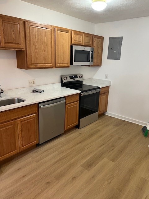 675 Washington Street, Unit 1 Brookline, MA 02446 - Photo 11 of 16 a kitchen with stainless steel appliances granite countertop a stove a sink and a microwave