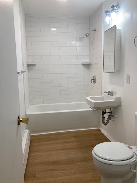 675 Washington Street, Unit 1 Brookline, MA 02446 - Photo 15 of 16 a bathroom with a sink toilet and shower