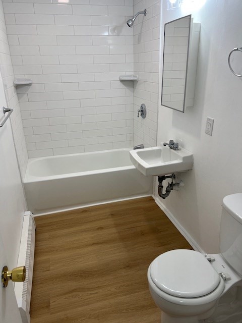 675 Washington Street, Unit 1 Brookline, MA 02446 - Photo 3 of 16 a bathroom with a sink toilet and shower