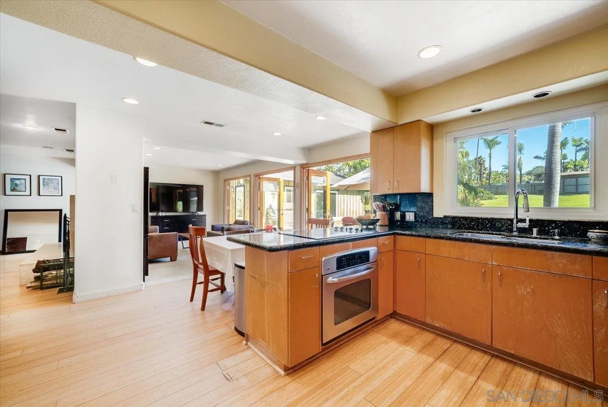 1386 Lake Drive Encinitas, CA 92024 - Photo 20 of 60 a kitchen with stainless steel appliances granite countertop a stove and a sink