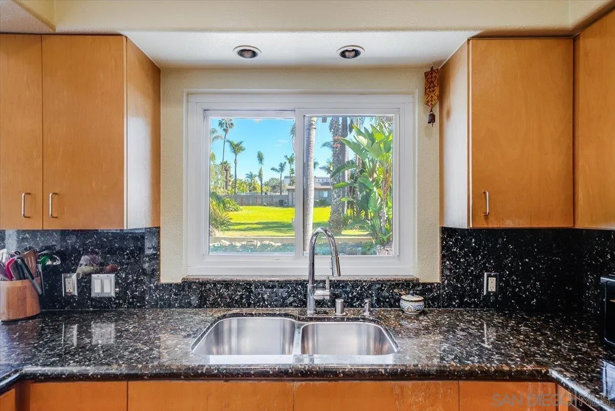 1386 Lake Drive Encinitas, CA 92024 - Photo 21 of 60 a kitchen with sink a window and cabinets