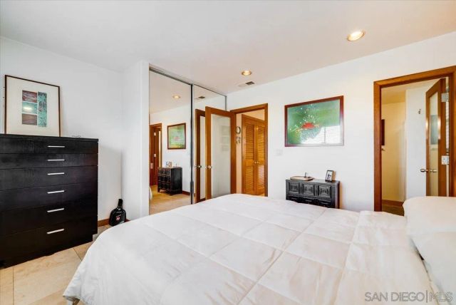 a view of a hallway with shelves and wooden floor