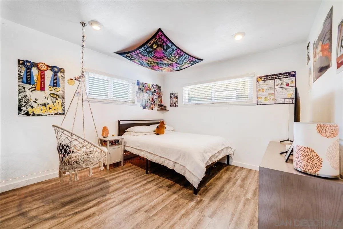 1386 Lake Drive Encinitas, CA 92024 - Photo 32 of 60 a bedroom with a bed and paintings on the wall