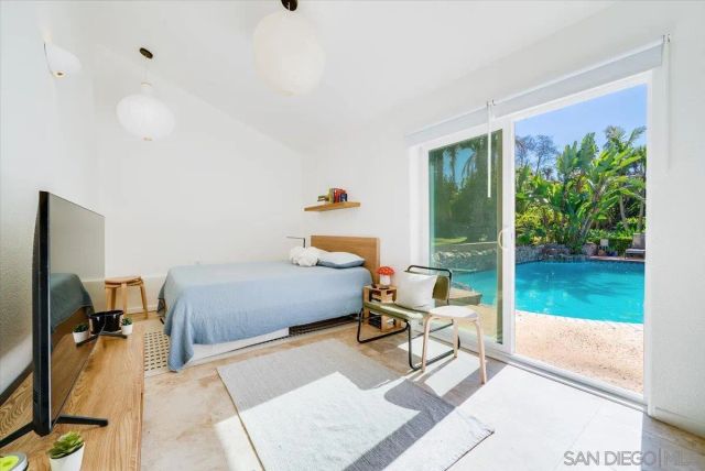 a view of a house with swimming pool and sitting area