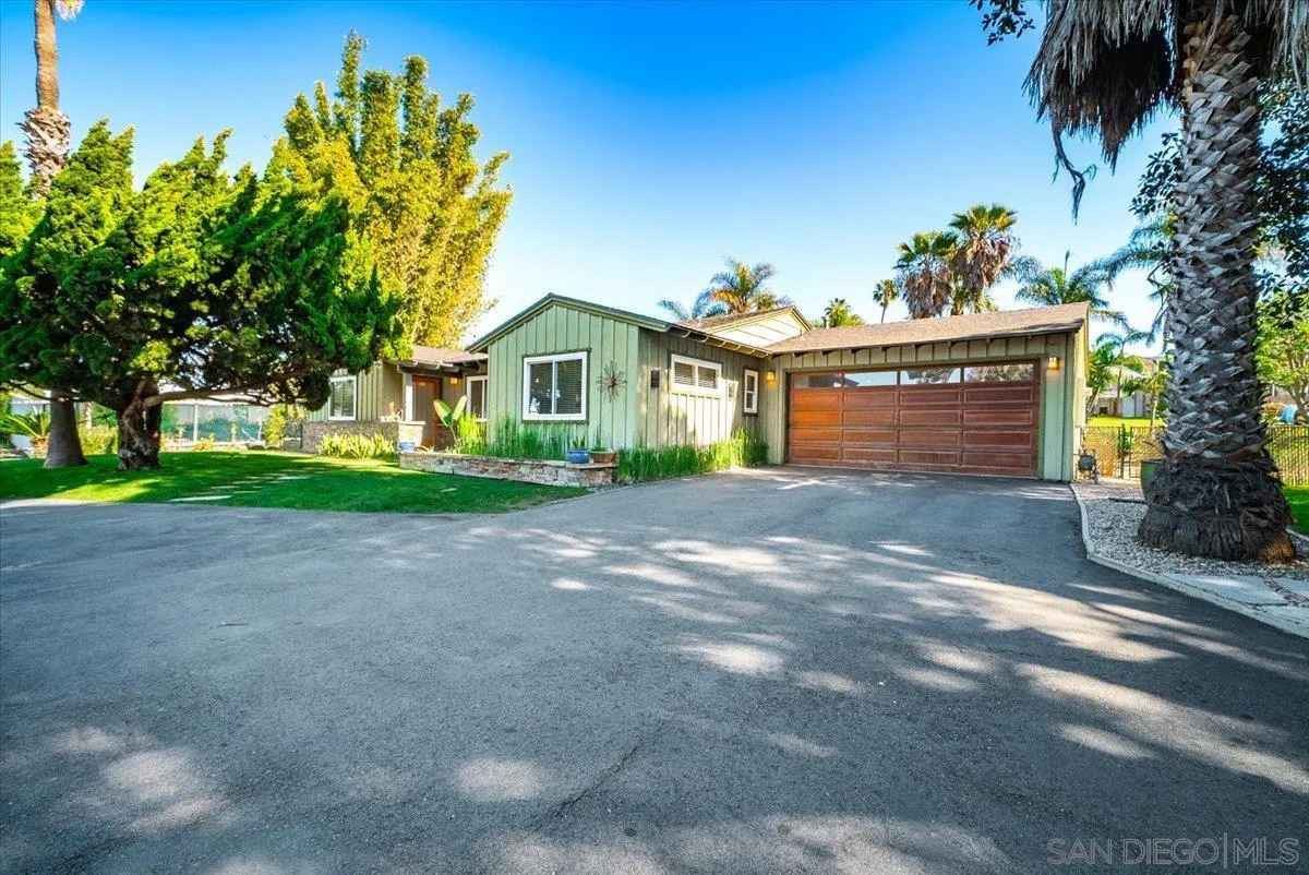 1386 Lake Drive Encinitas, CA 92024 - Photo 56 of 60 a front view of a house with a yard and garage