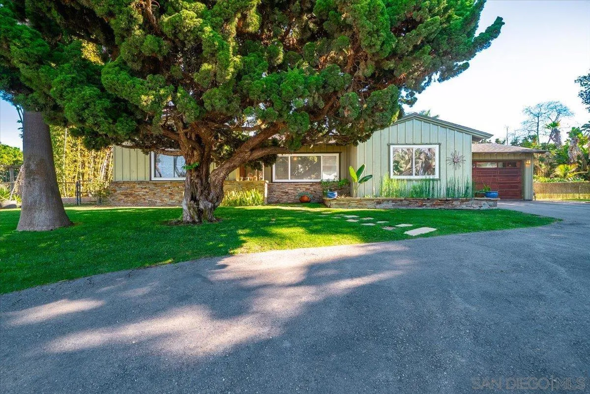 1386 Lake Drive Encinitas, CA 92024 - Photo 57 of 60 a front view of a house with a yard and garage