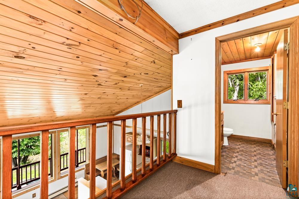 740 Seboe Road Wrenshall, MN 55797 - Photo 11 of 20 Hall with wooden ceiling, carpet, a wealth of natural light, and vaulted ceiling