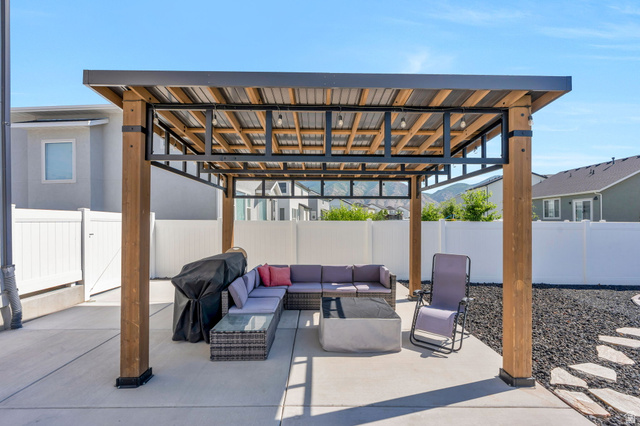 252 North Sunrise Rnch Drive Mapleton, UT 84664 - Photo 8 of 62 Expansive patio featuring a contemporary pergola with a metal roof and exposed wood beams