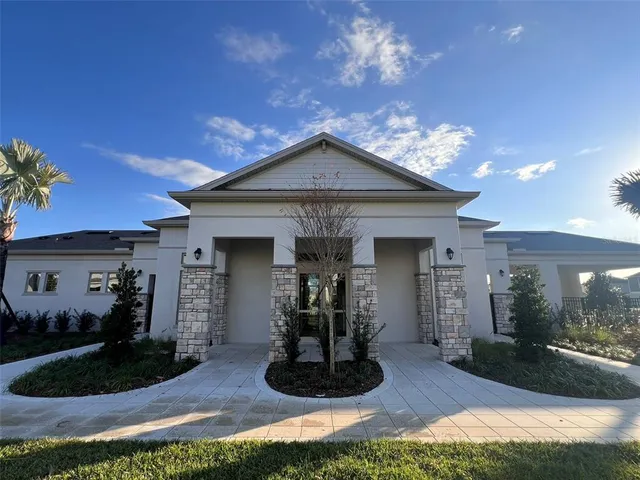 a view of a house with swimming pool and sitting area