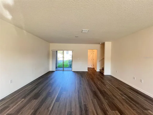 a view of room with window and wooden floor