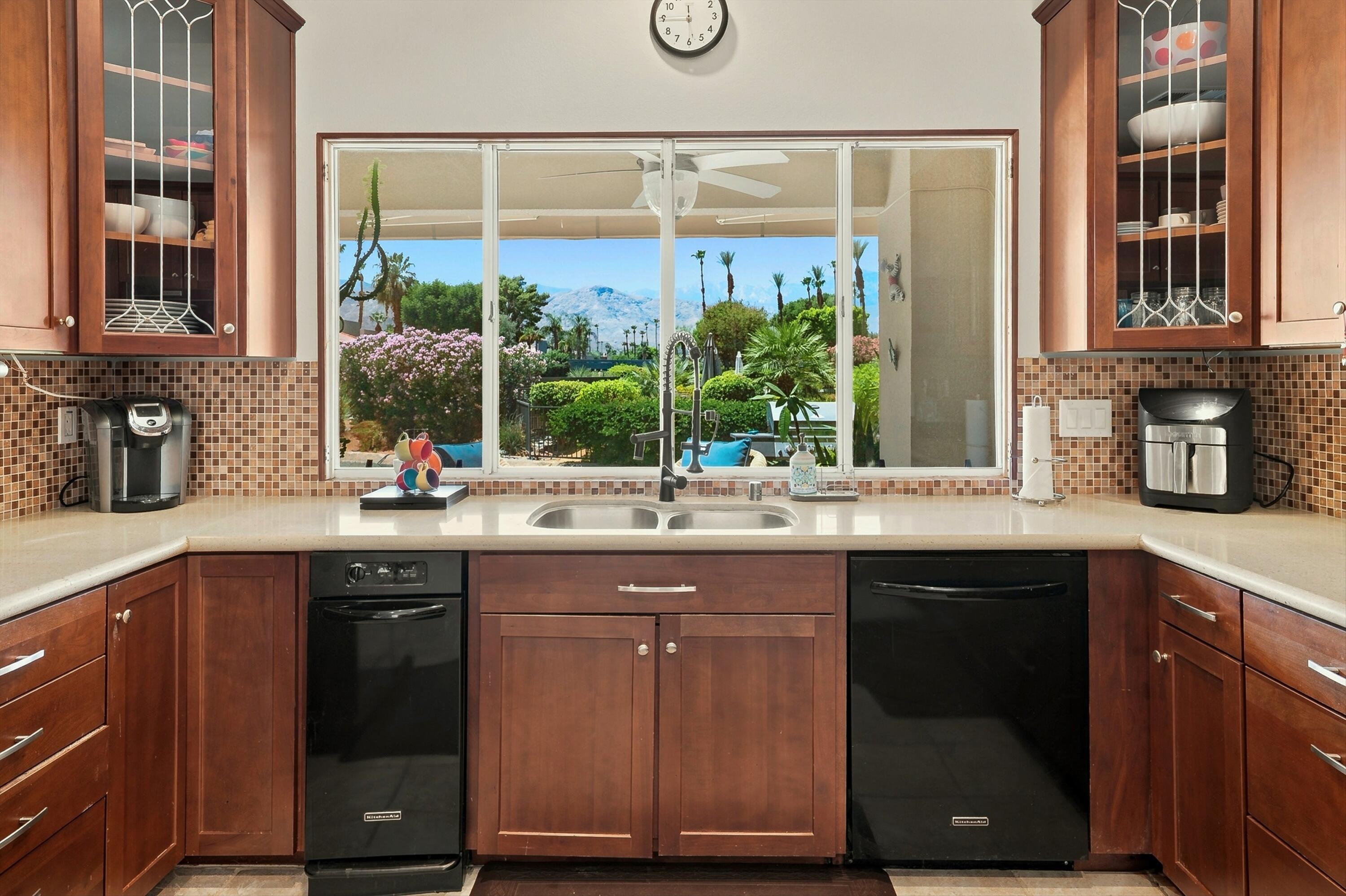 138 Lakeshore Drive Rancho Mirage, CA 92270 - Photo 8 of 30 a kitchen with stainless steel appliances granite countertop a sink and wooden cabinets