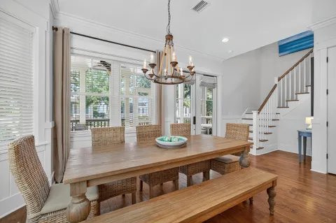 a view of a dining room with furniture wooden floor and chandelier