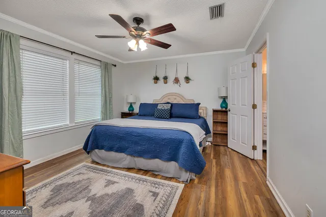 a bedroom with a large bed and a window