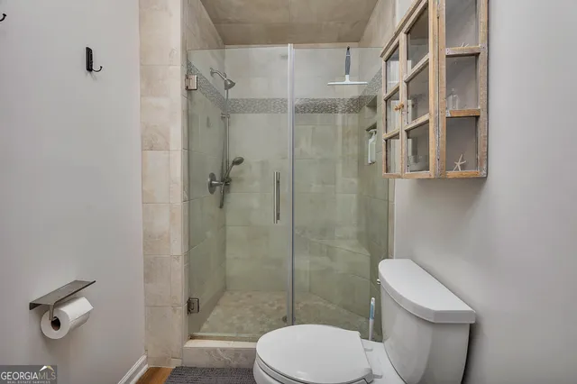 a white toilet sitting next to a bathroom sink