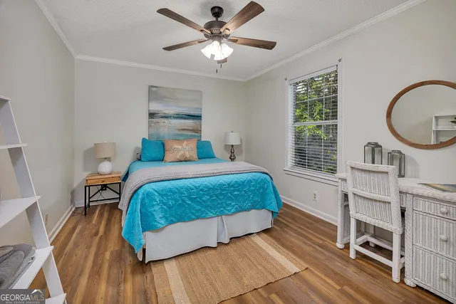 a bedroom with a bed window and a table