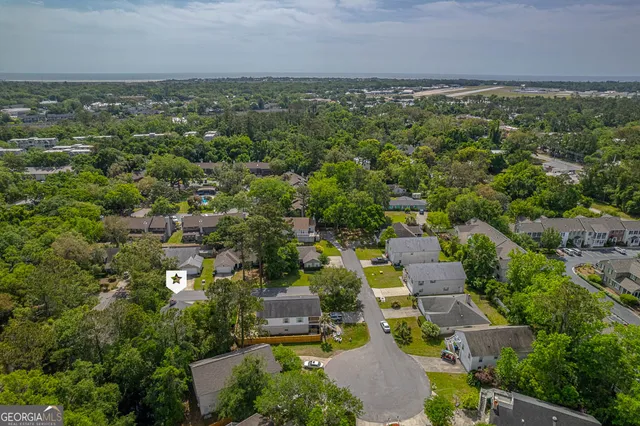 an aerial view of a houses with a yard