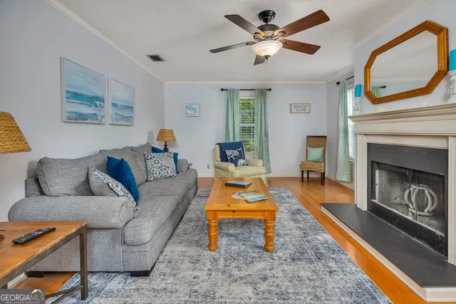 a living room with furniture a fireplace and a large window