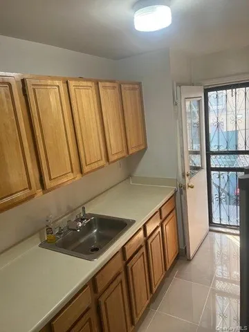 a kitchen with a sink and a stove top oven