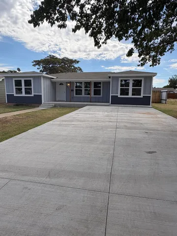 front view of a house with a garden