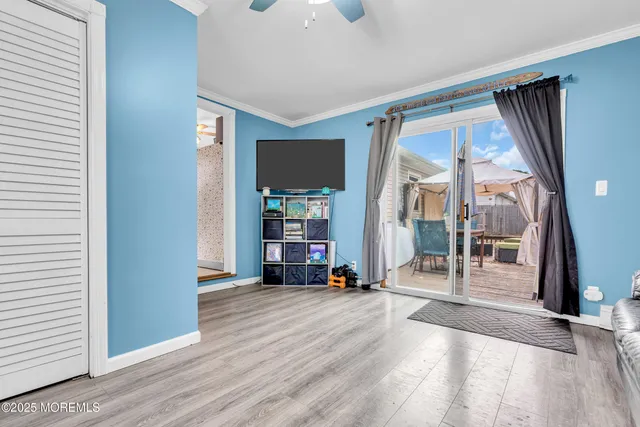 a view of a living room with a large window and wooden floor