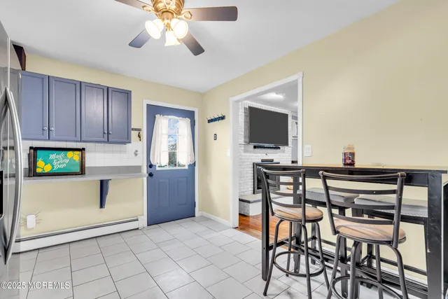 a view of a dining room with furniture and chandelier