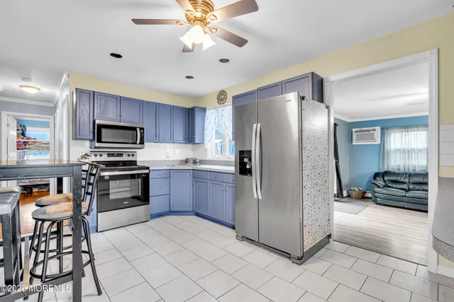 a kitchen with stainless steel appliances granite countertop a refrigerator a stove and a sink