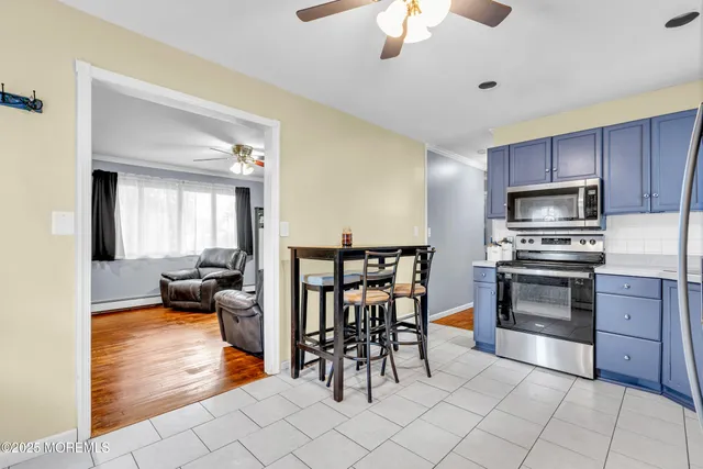 a kitchen with granite countertop a stove a sink and a refrigerator