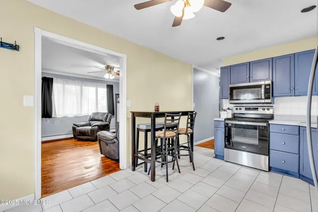 a kitchen with granite countertop a stove a sink and a refrigerator