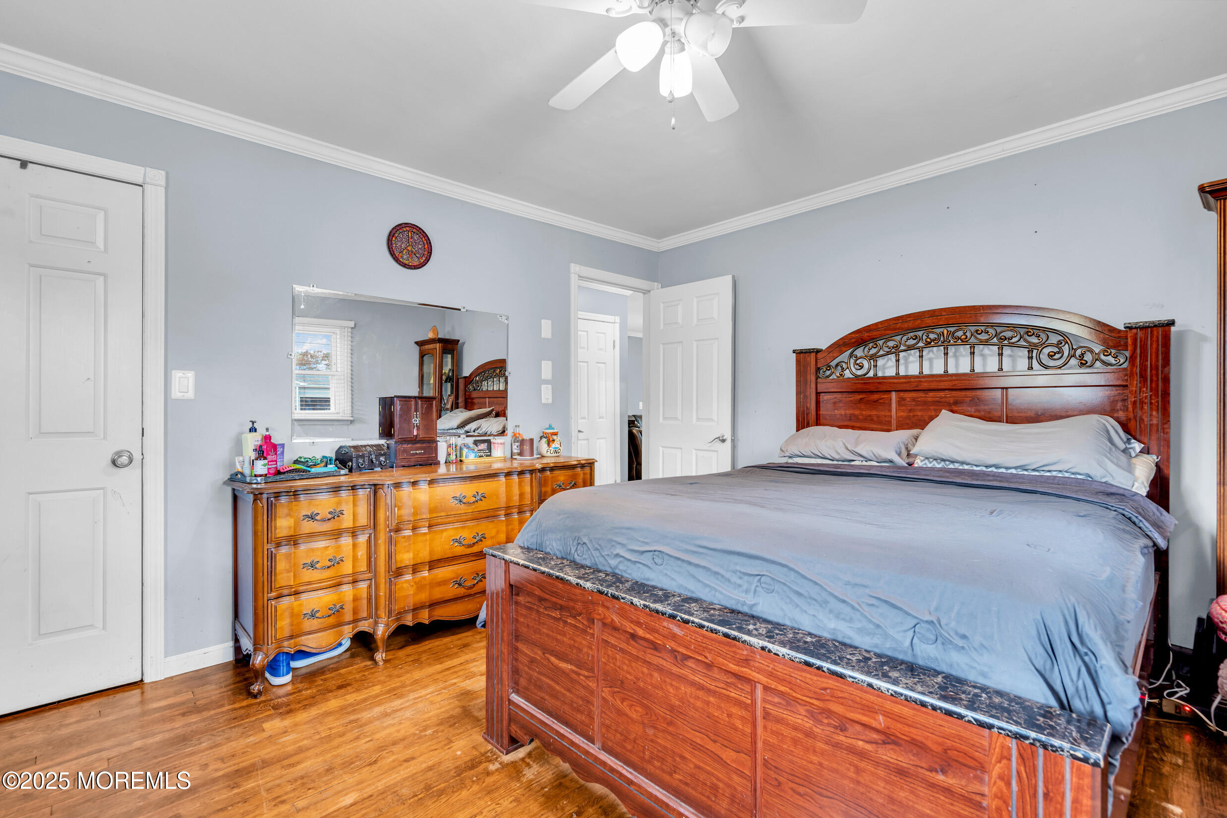 1541 Commonwealth Boulevard Toms River, NJ 08757 - Photo 23 of 34 a bedroom with a bed and a chandelier